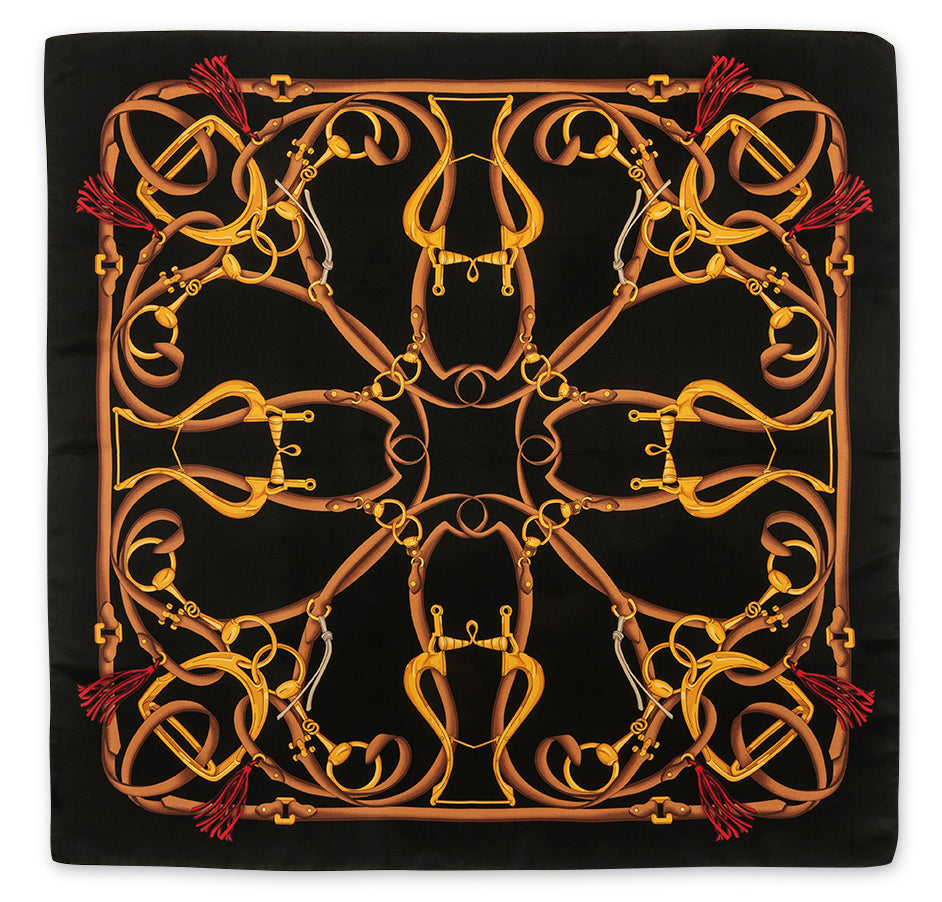 A square black scarf featuring a symmetrical, kaleidoscopic pattern of golden-yellow and brown horse bits and reins, accented with small red tassels at the corners.
