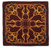 A square silk scarf featuring an intricate equestrian design with golden horse bits and reins on a dark brown background, finished with green tassels in the corners.