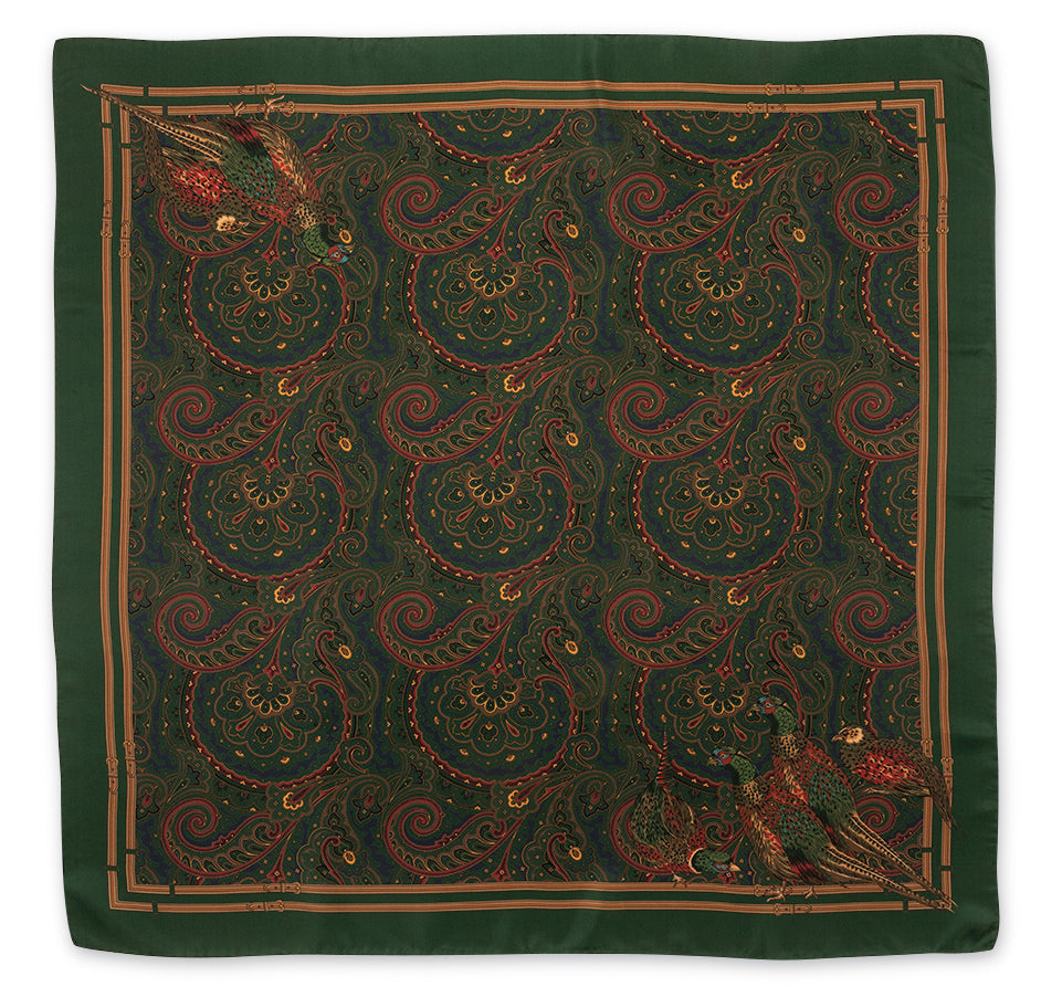 A square silk scarf featuring an intricate paisley pattern in dark green, rust red, and gold, with decorative bird motifs in the corners, shown flat against a white background.