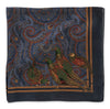 A square silk scarf featuring a detailed print of pheasants on a dark blue background with intricate paisley patterns and gold borders.