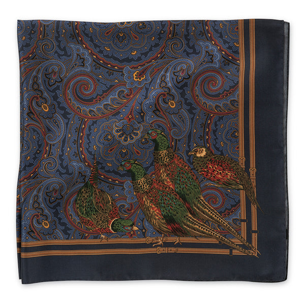 A square silk scarf featuring a detailed print of pheasants on a dark blue background with intricate paisley patterns and gold borders.